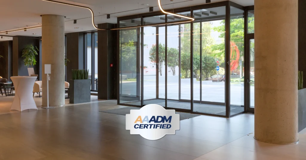 AAADM certification logo in front of automatic sliding doors