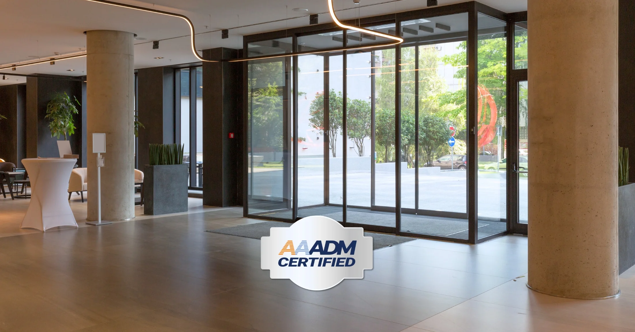 AAADM certification logo in front of automatic sliding doors